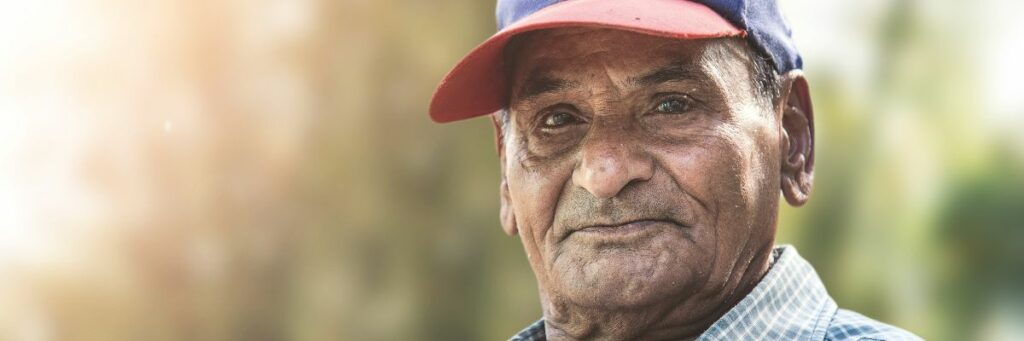 Closeup on the face of older man wearing a baseball hat