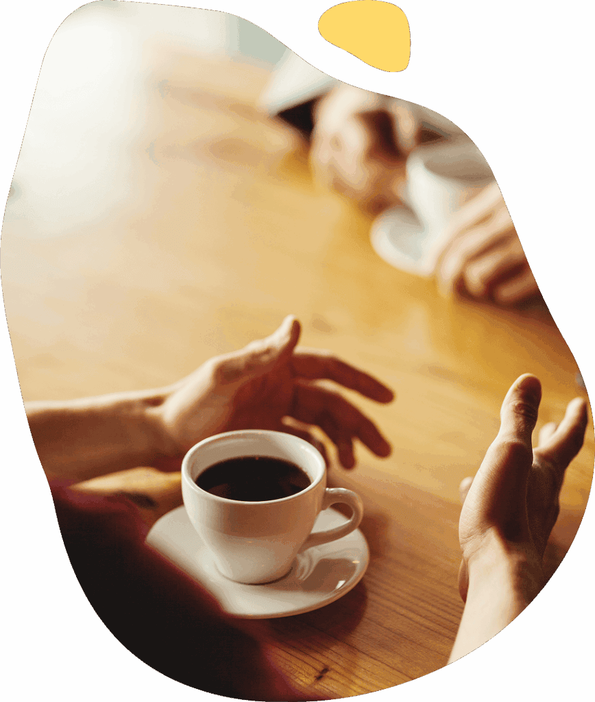people having a conversation over coffee